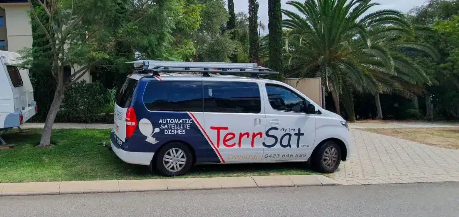 A photo of the TerrSat van, next to a camper van.