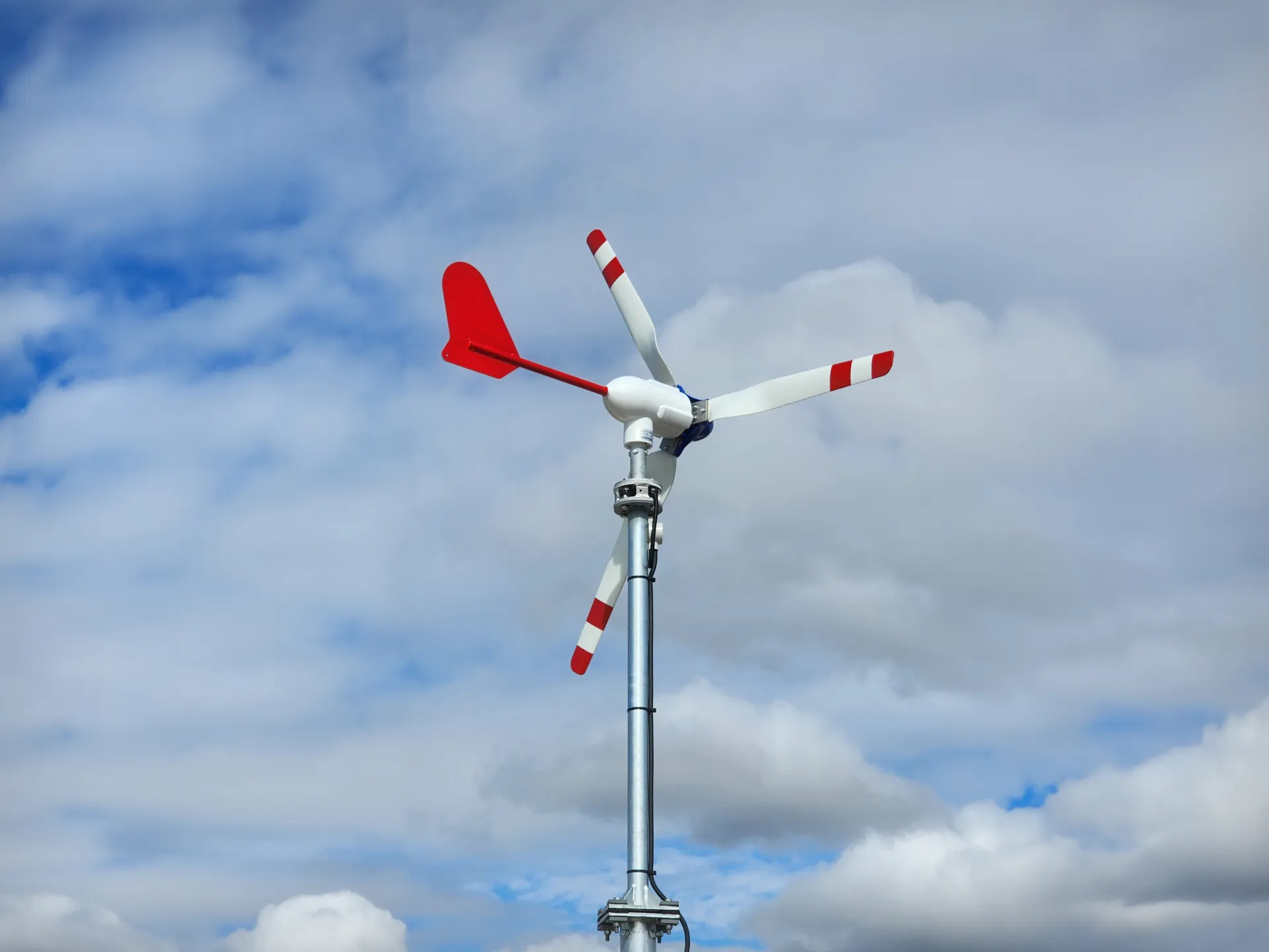 A photo of a wind turbine, facing backwards.
